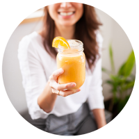 Woman holding smoothie in glass jar