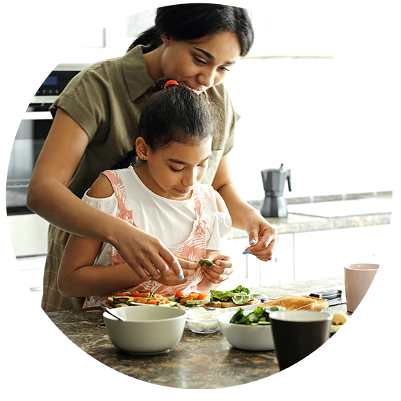 Mother and daughter preparing food